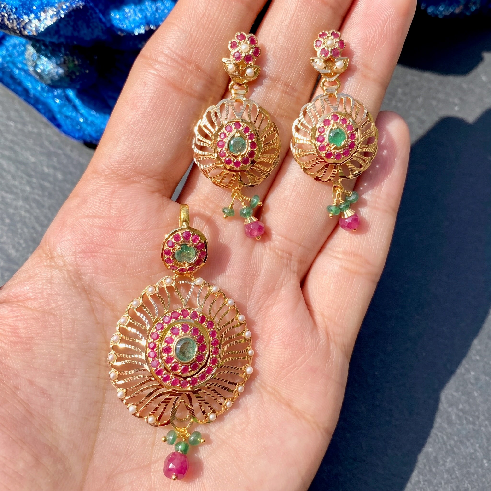 exquisite 22k gold pendant set studded with emeralds and rubies