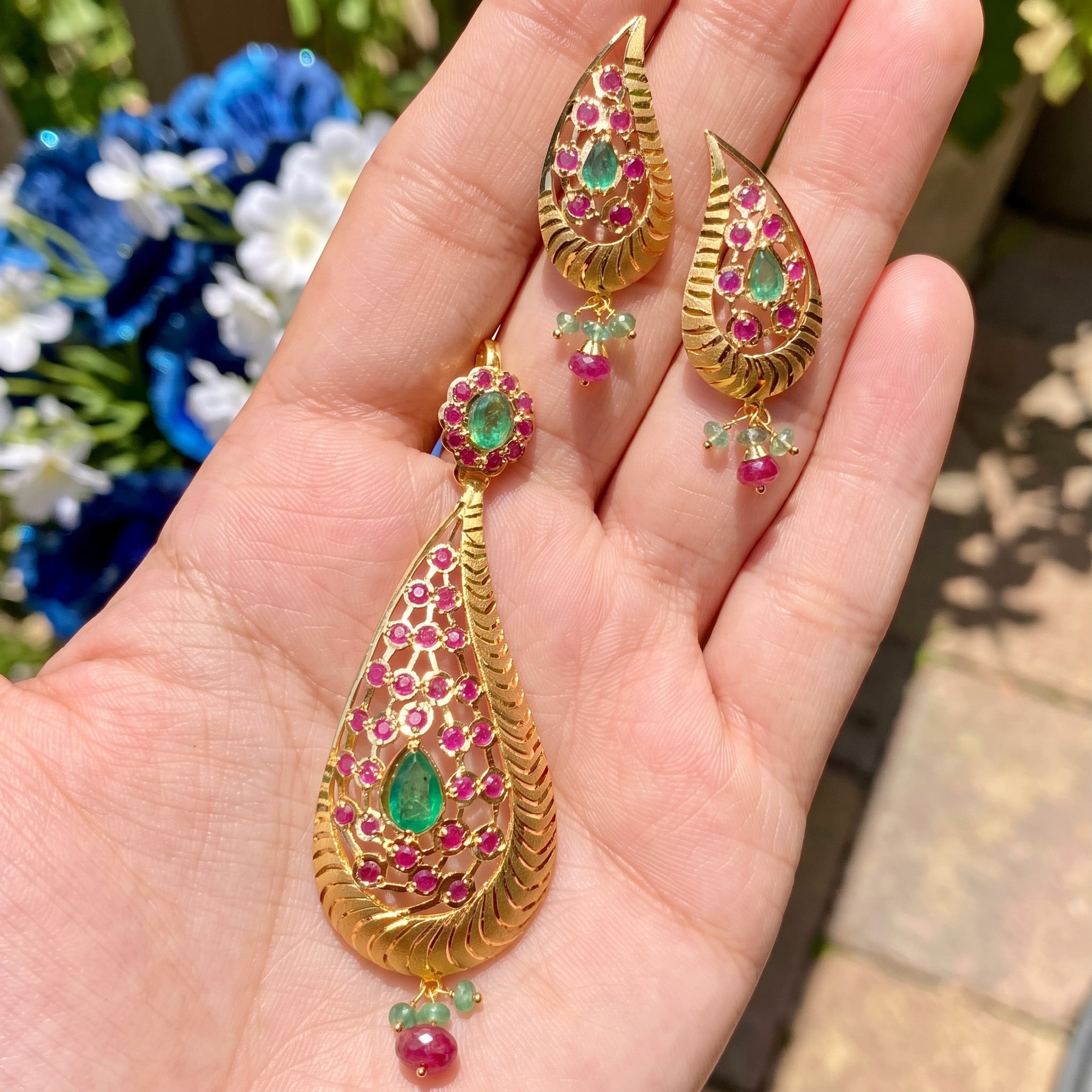 gold pendant set with emeralds and rubies