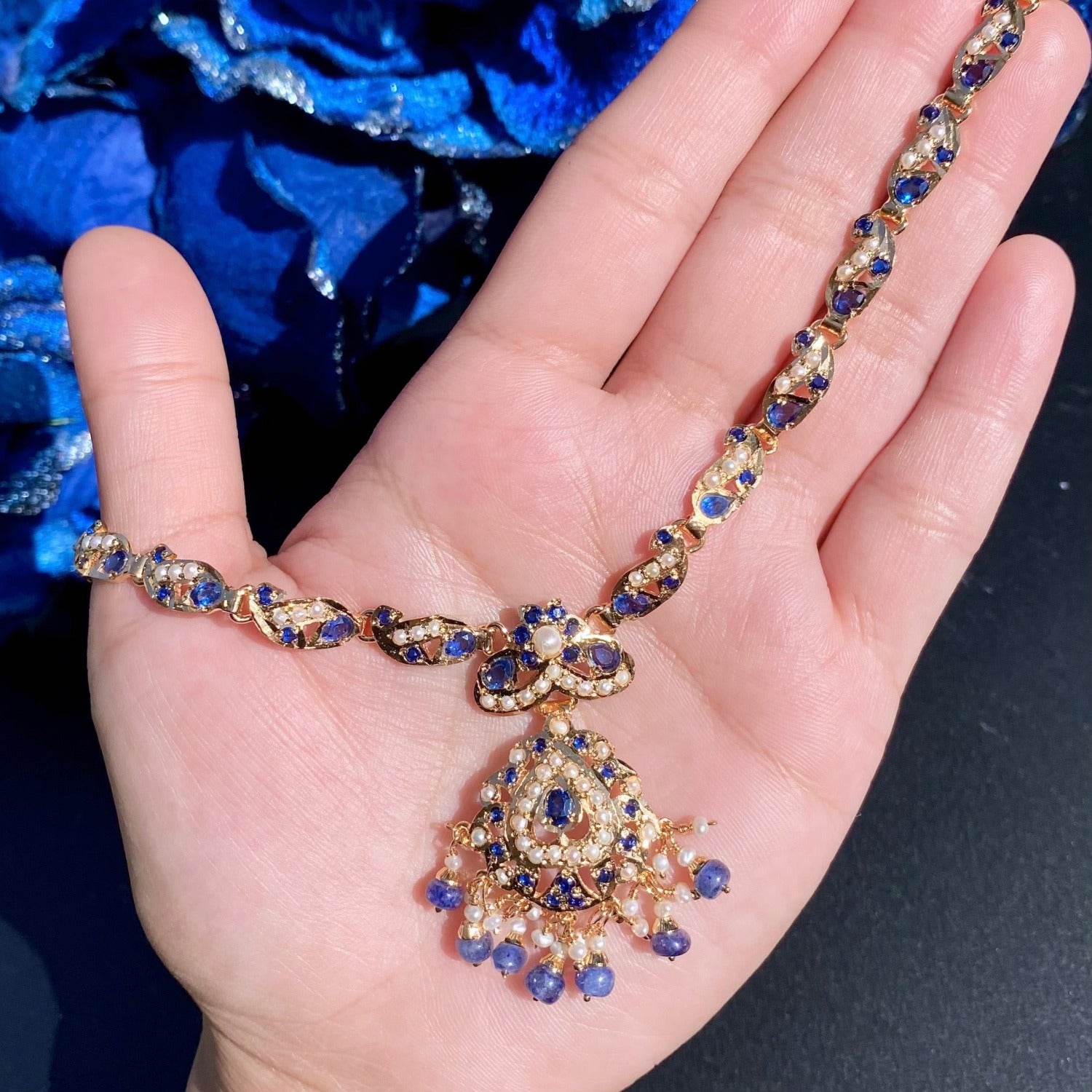 dainty blue sapphire necklace with statement earrings