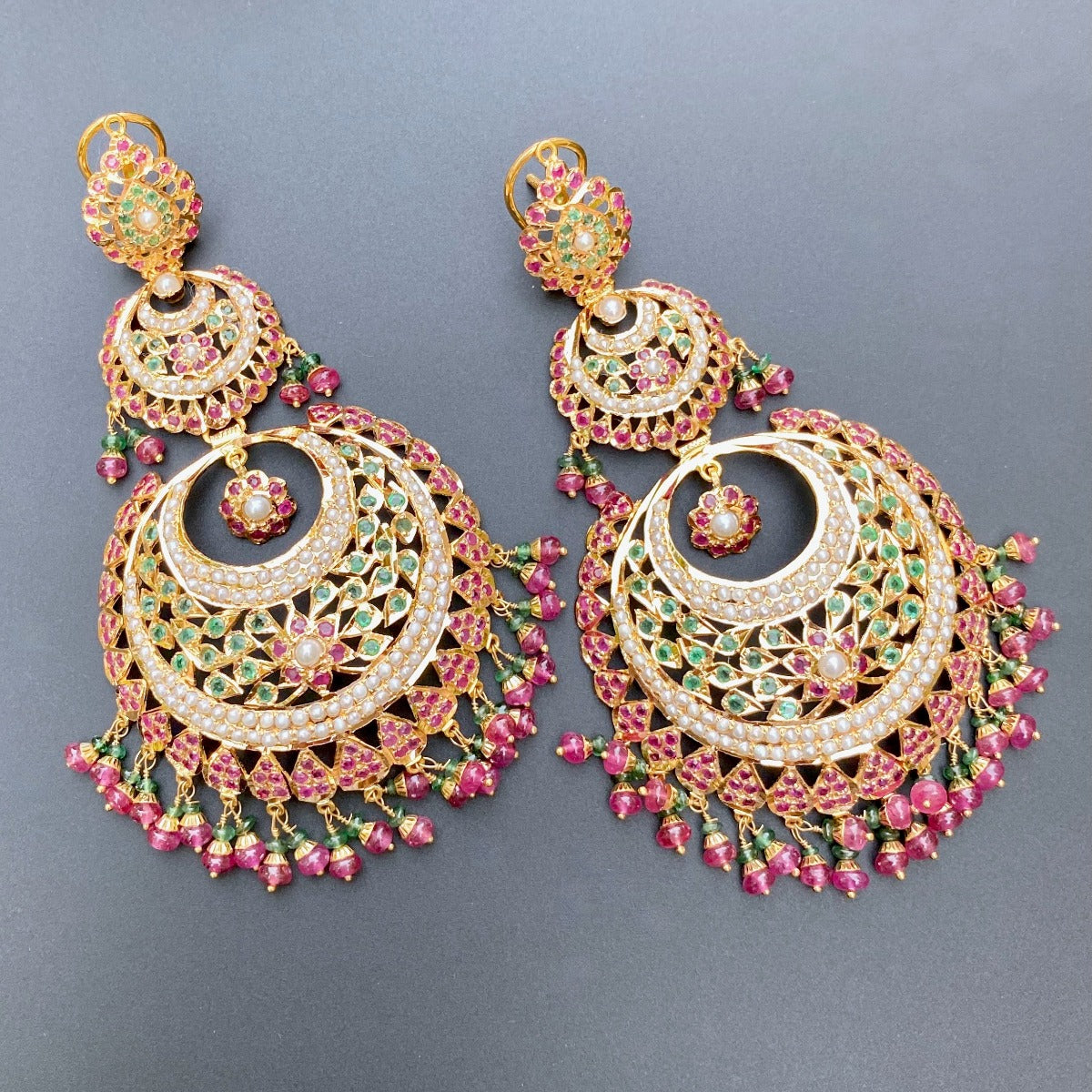 rajasthani chandbali jhumkas in gold studded with ruby emerald