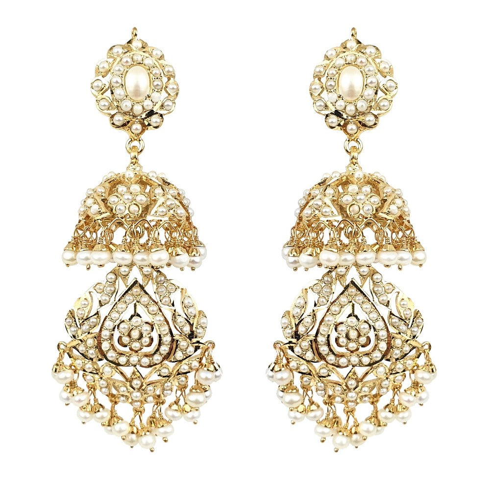 Gold and pearl earrings on a white background