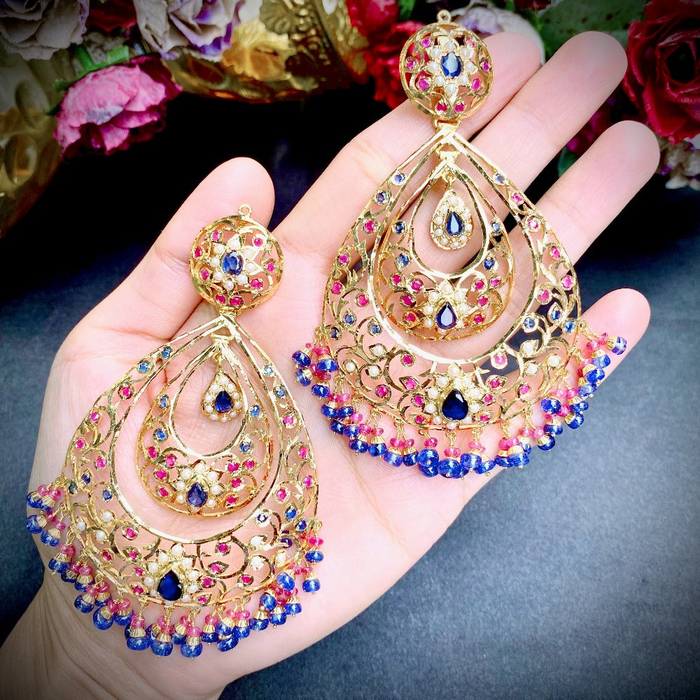 big gold chandbali earrings studded with ruby and blue sapphires