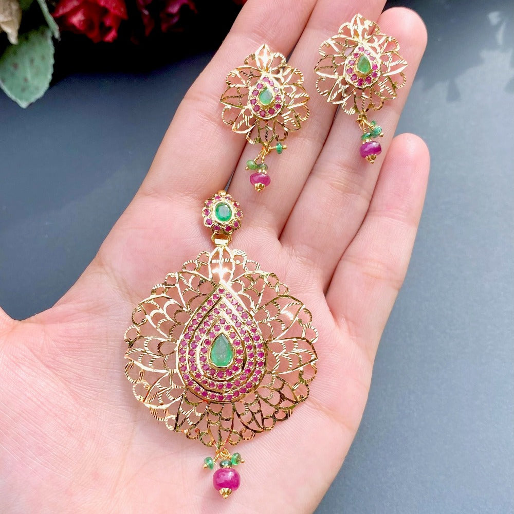 gold pendant set with ruby and emerald