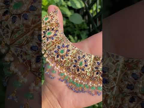 bridal necklac set in gold studded with pearls, emeralds and blue sapphires
