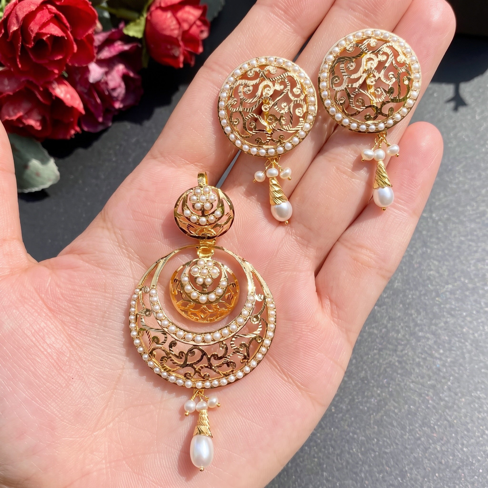 gold pendant set studded with pearls