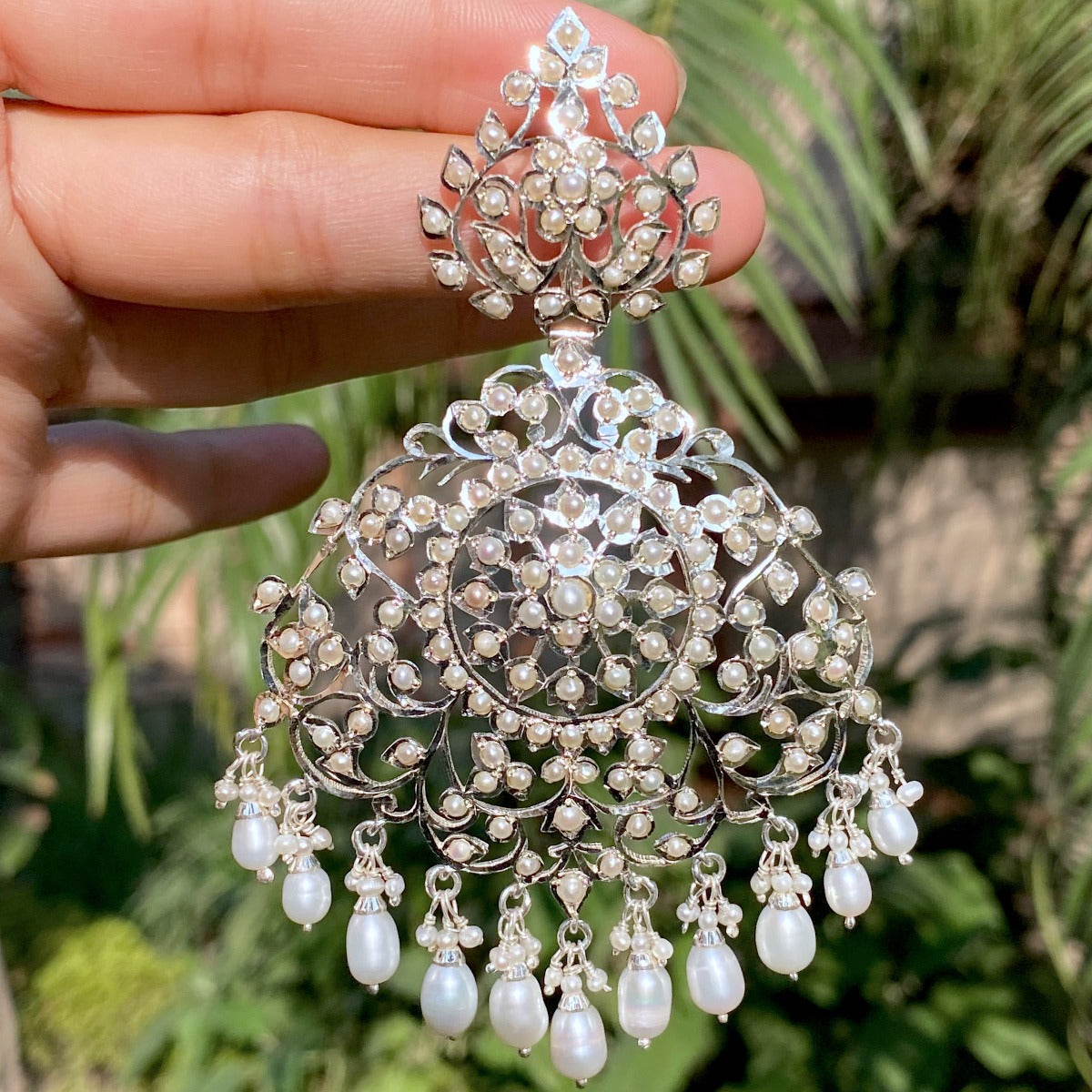 oversized silver earrings studded with seed pearls