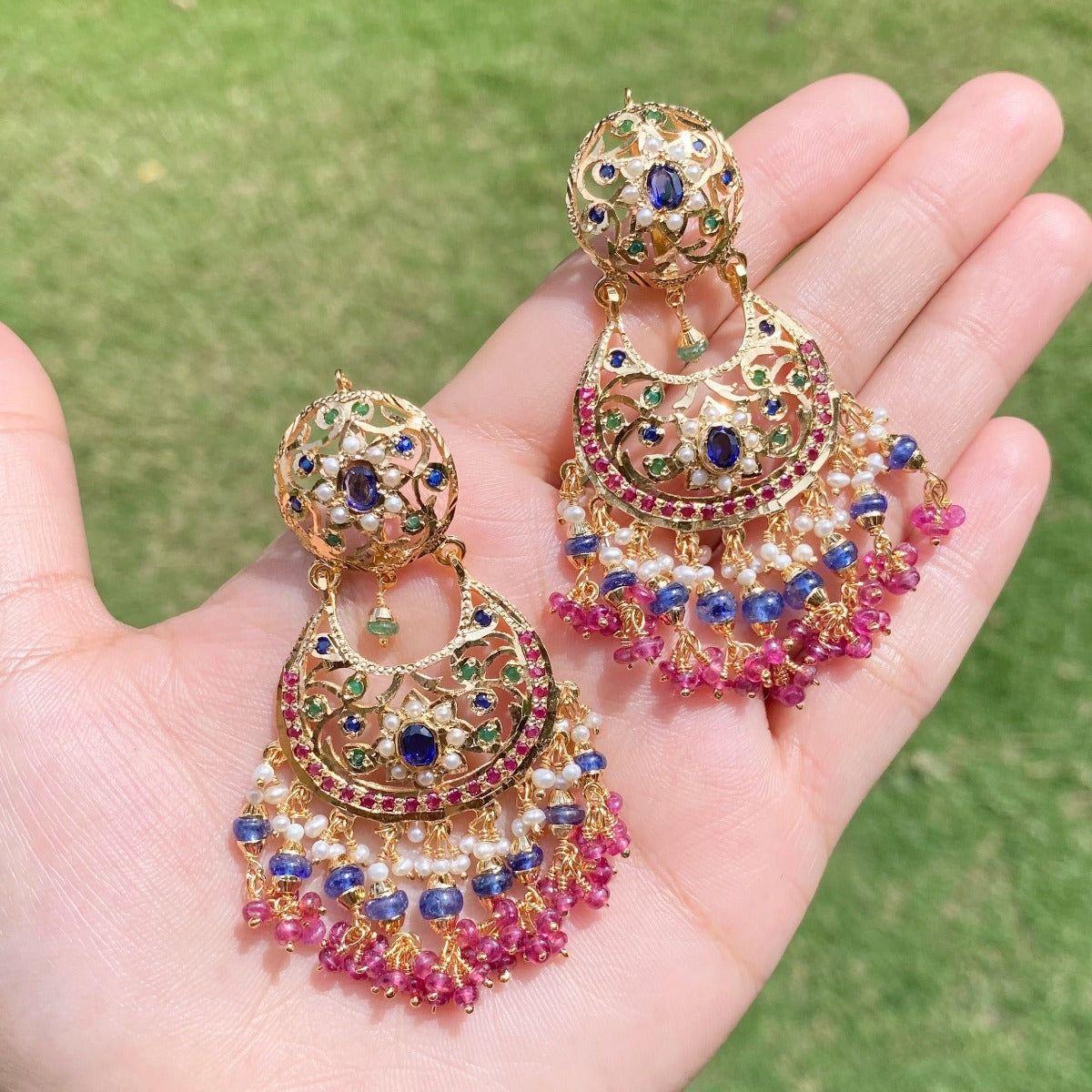 gold polished chandbalis with ruby bunches and blue sapphires