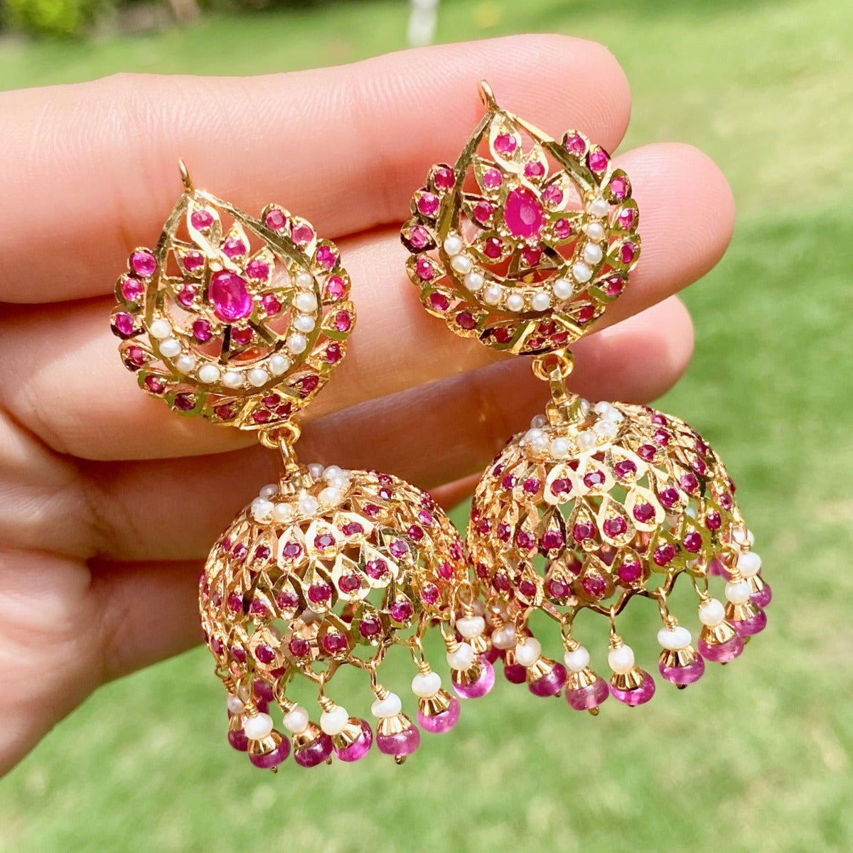 gold plated jhumka earrings studded with ruby and pearls on 925 silver