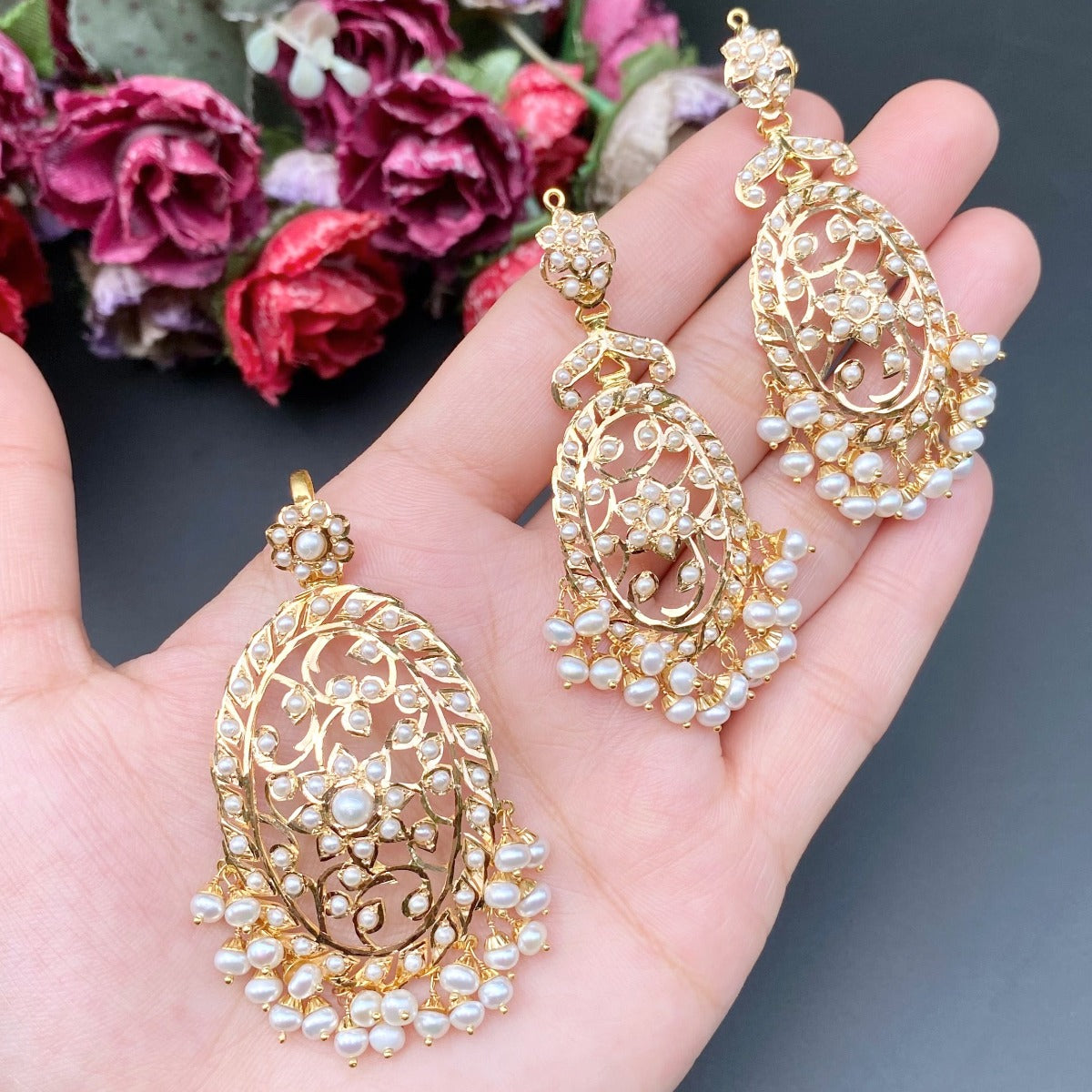 gold pendant set studded with freshwater pearls