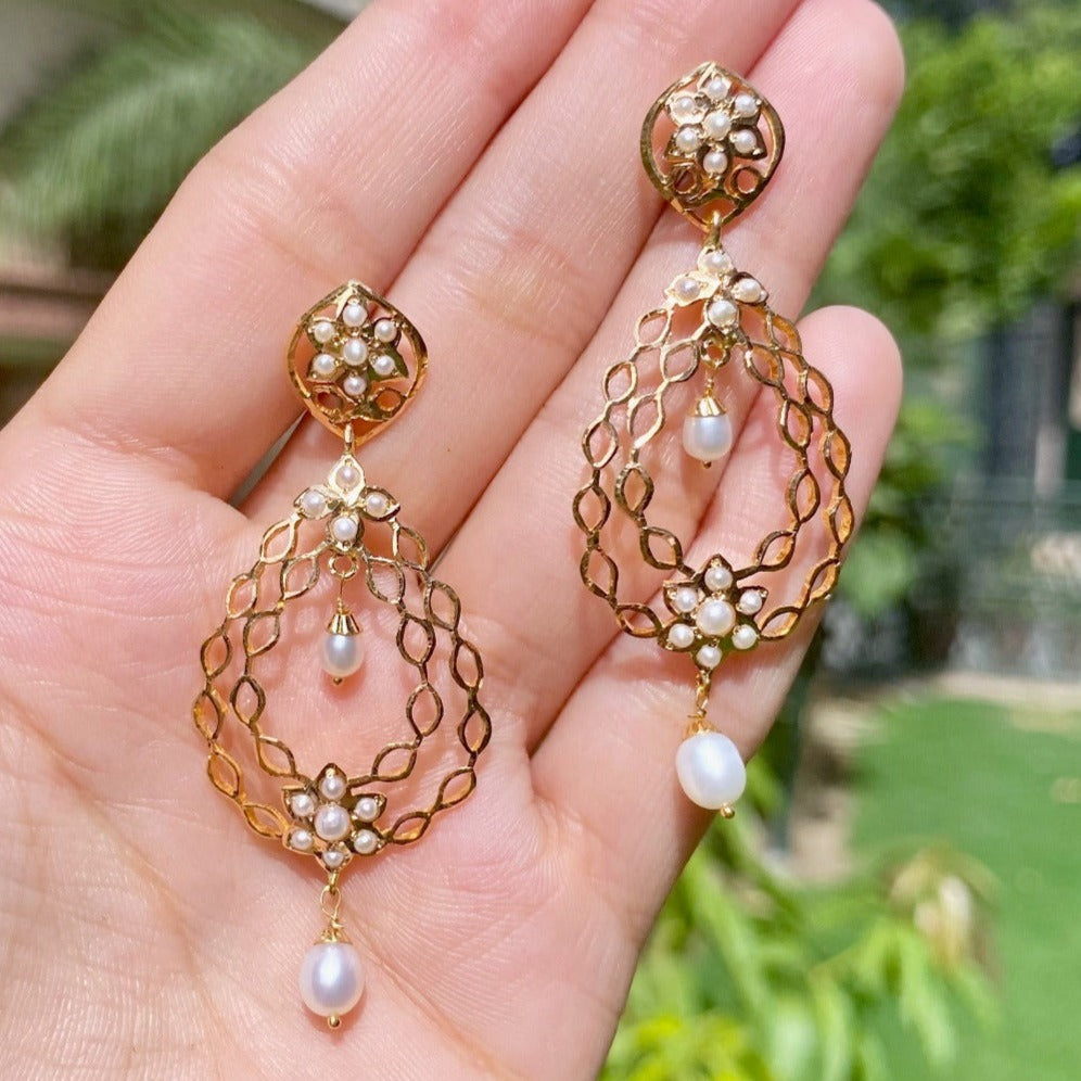 dainty pearl earrings on gold