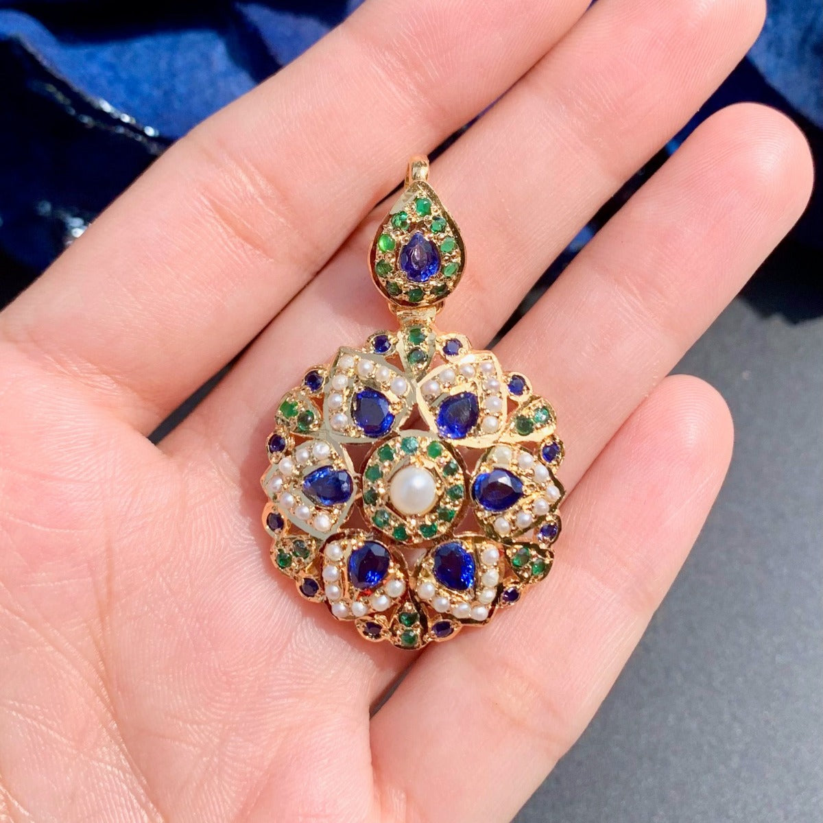 gold plated jadau pendant with emeralds and neelam