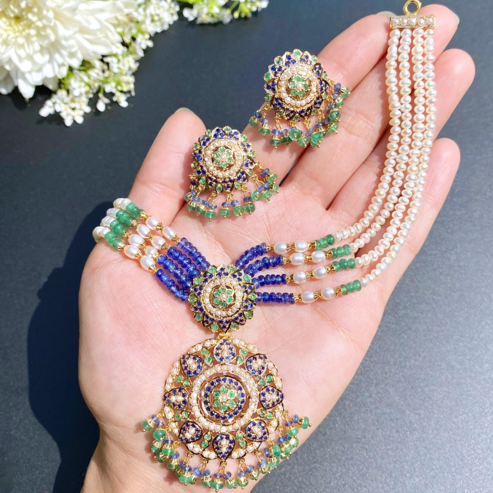 finely handcrafted jewelry studded with emeralds pearls and blue sapphire