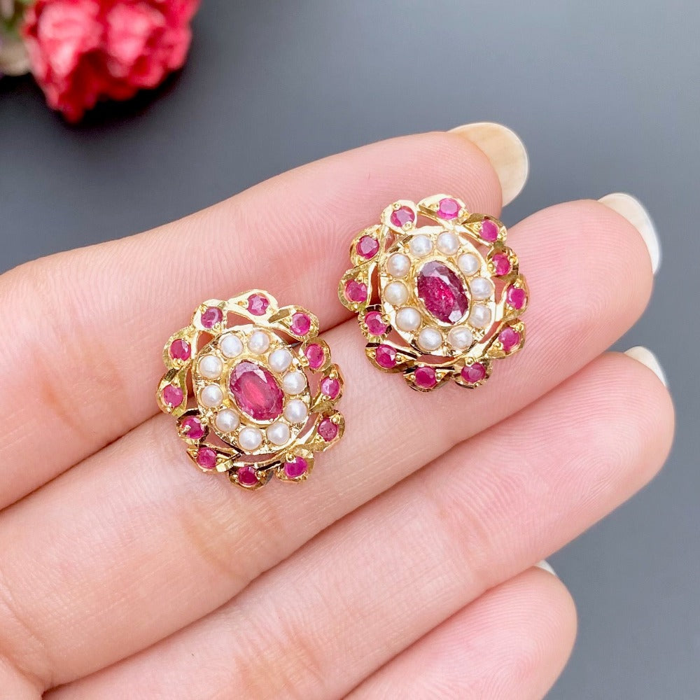 oval studs in gold studded with rubies and pearls