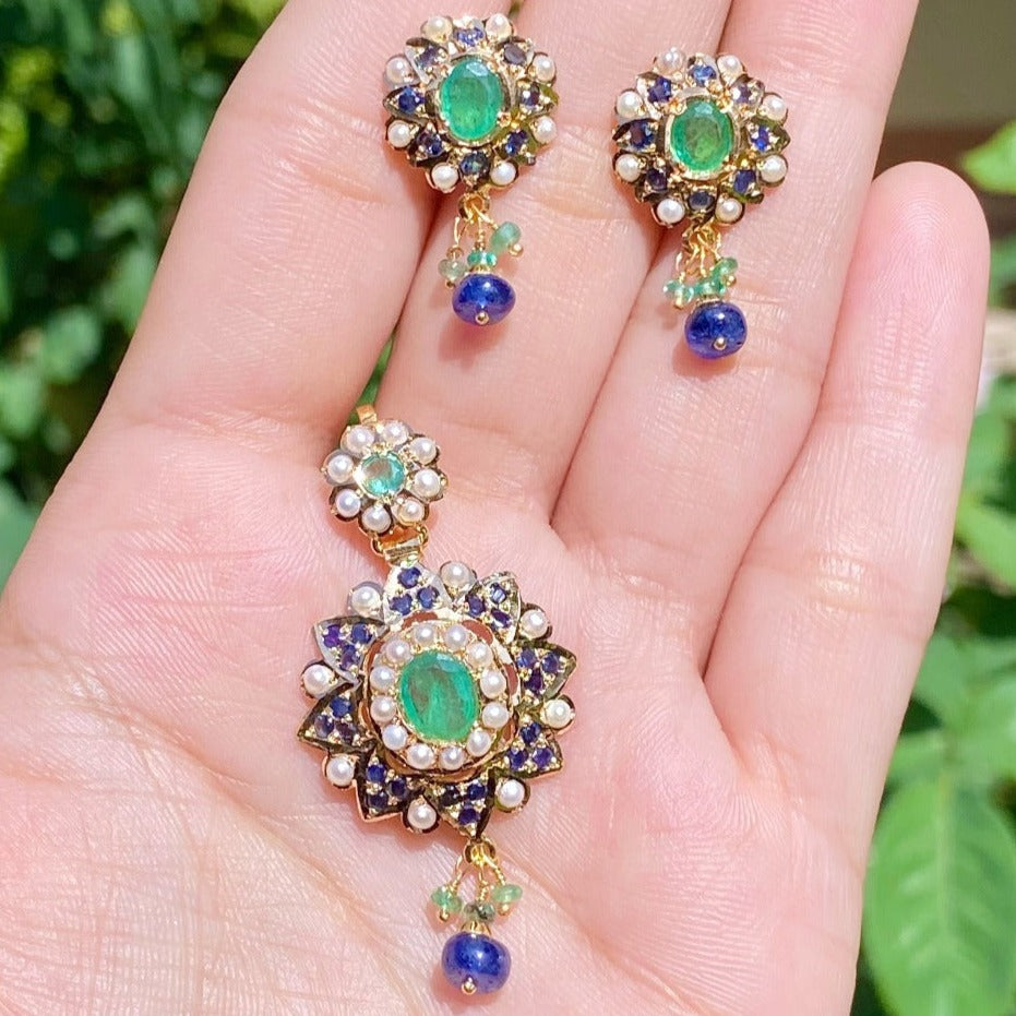 gold pendant set studded with emerald and sapphire