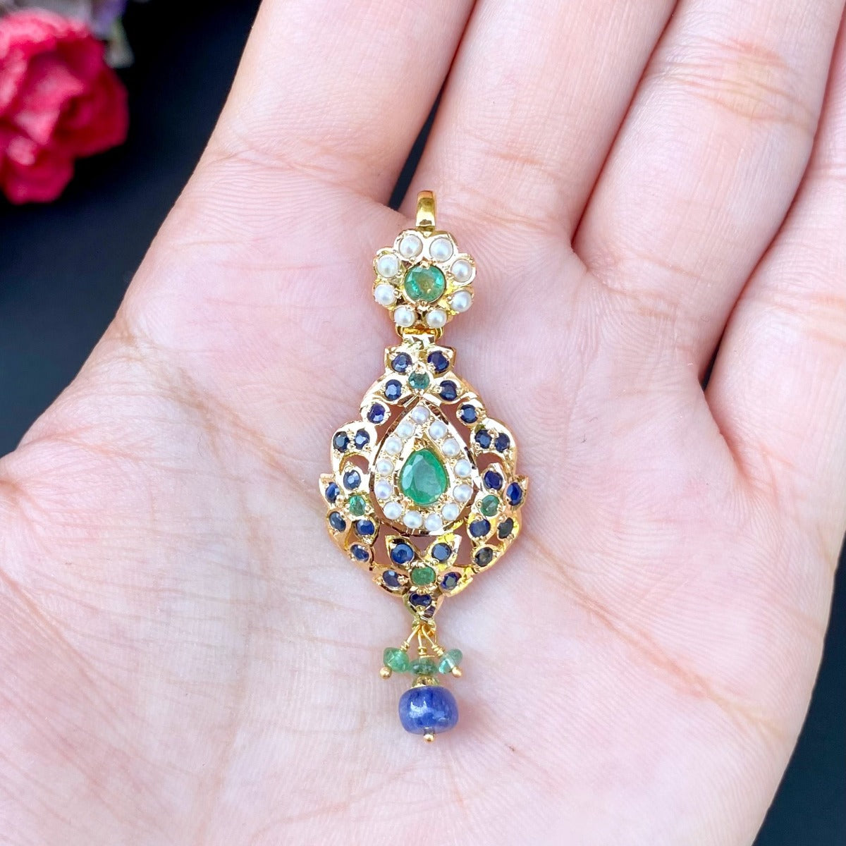 gold pendant studded with emeralds, sapphires and pearls