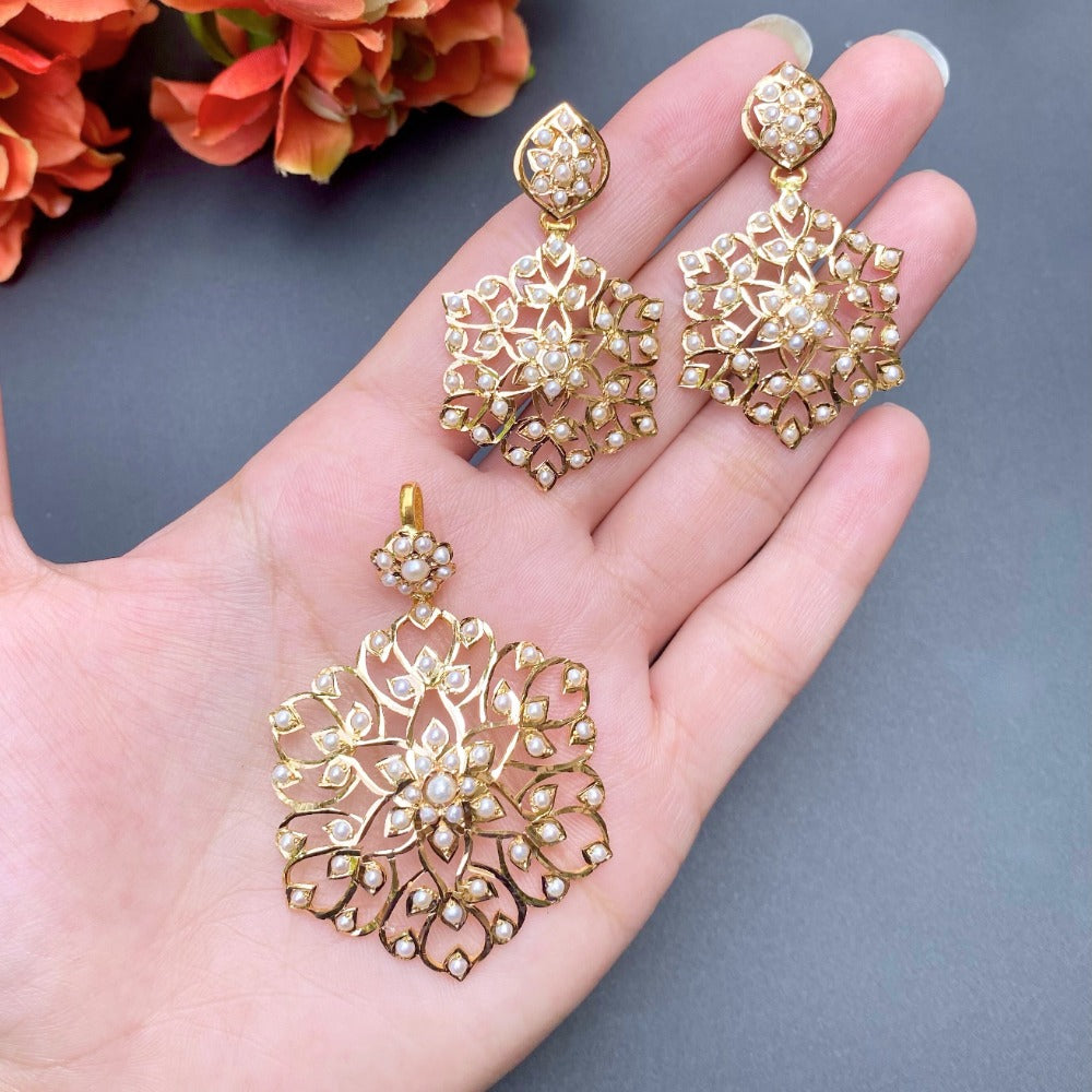 gold pendant and earrings