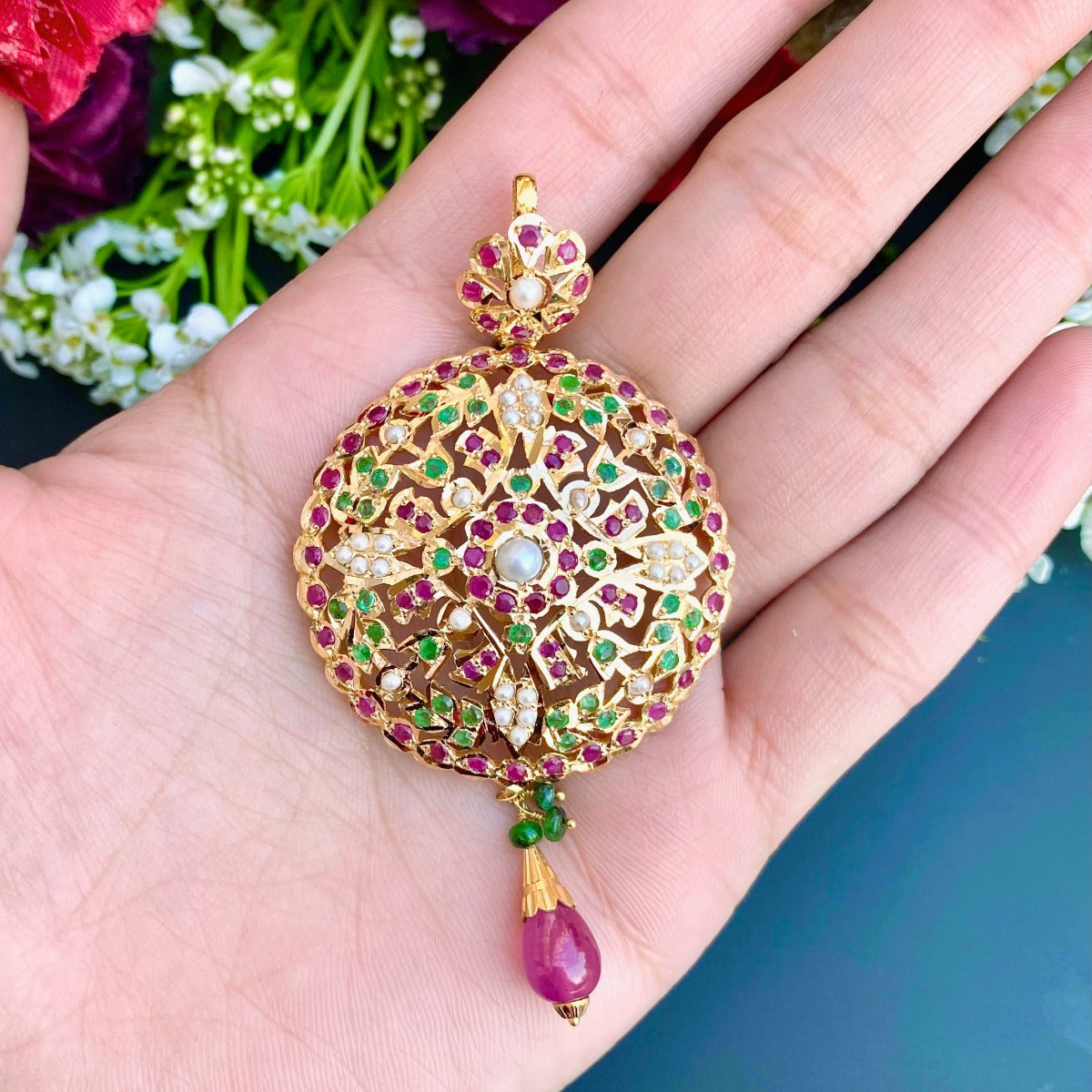 round gold pendant with rubies emeralds and pearls