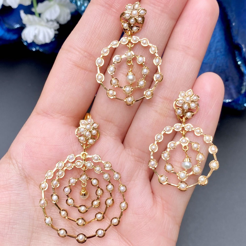 gold pendant set studded with pearls