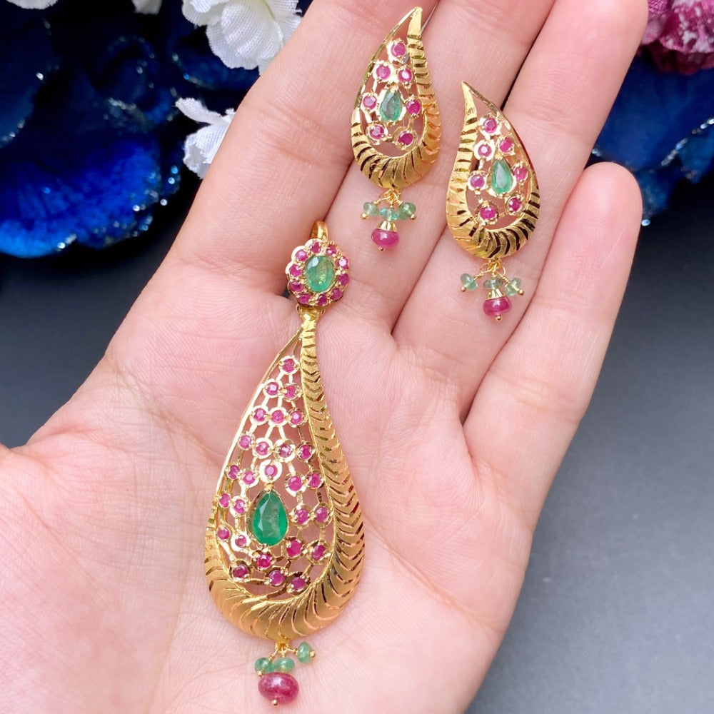 gold pendant set with emeralds and rubies