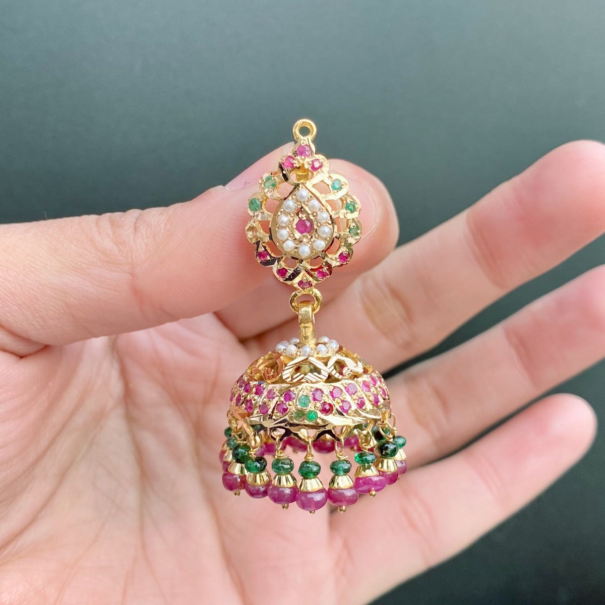 gold jhumka studded with ruby emerald and pearls