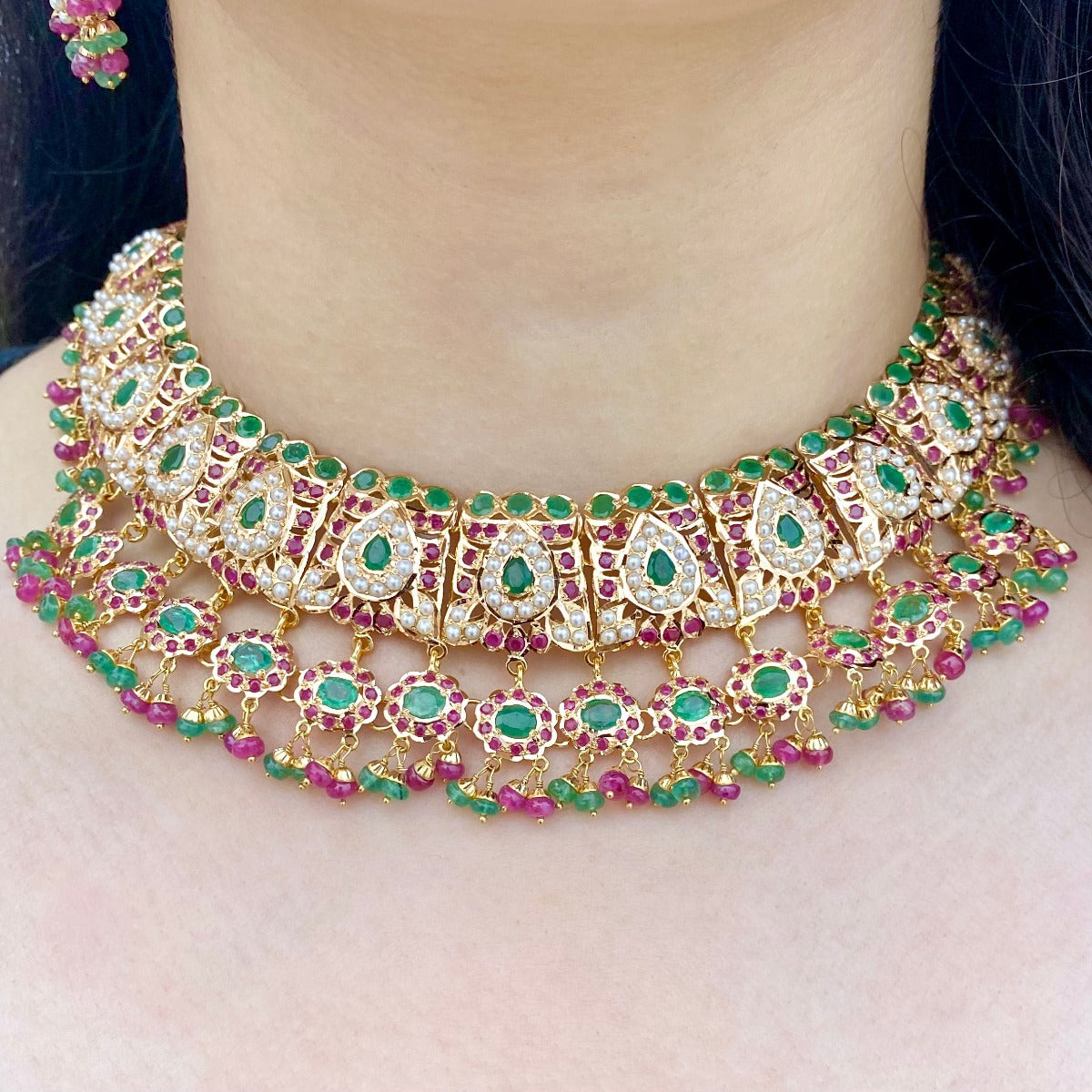 gold necklace with ruby emerald