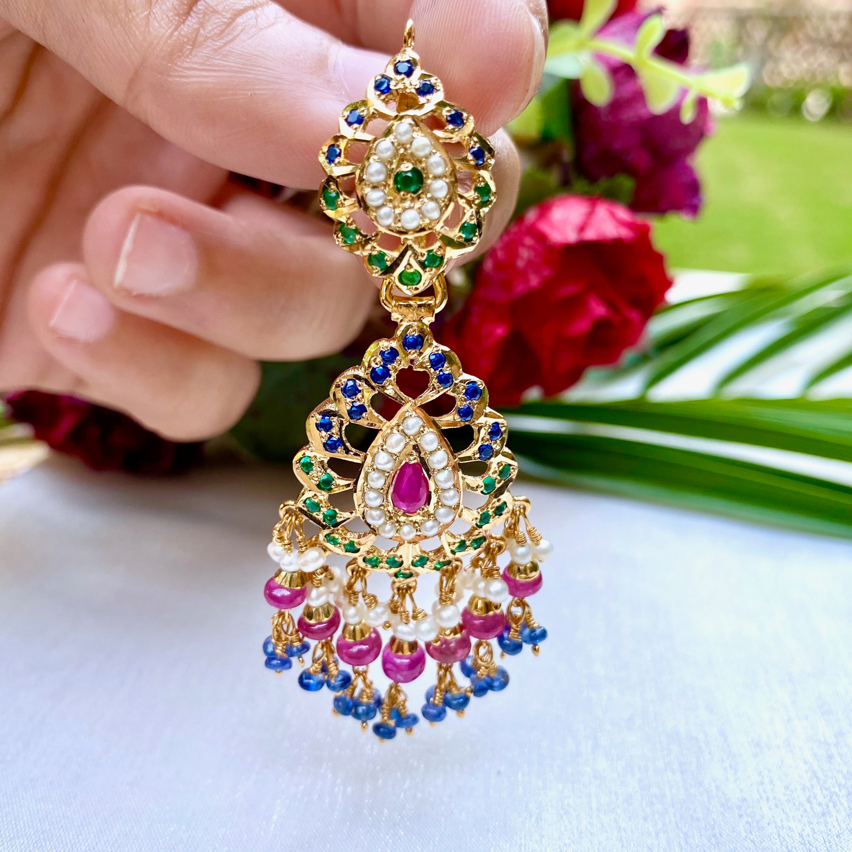 jadau earrings in ruby emerald and sapphire