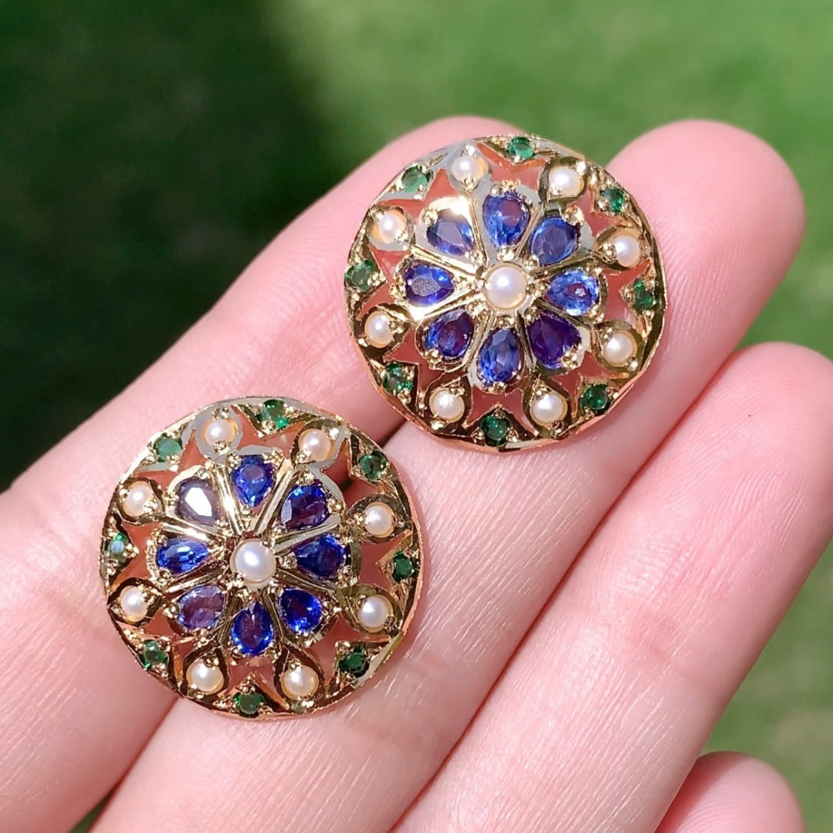 gold polished earrings studded with blue stones